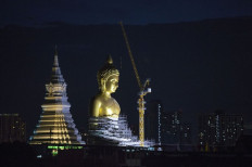 A new Buddha statue rises above Bangkok