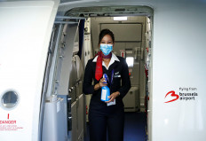 A flight attendant wearing a protective mask holds disinfectant spray onboard a Brussels Airlines aircraft before the take-off at the Zaventem International Airport, as Belgium eases restrictions aimed to contain the spread of the coronavirus disease (COVID-19) outbreak, near Brussels, Belgium June 15, 2020. 
