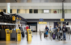 Passengers queue at a check-in desk of Schiphol airport, on June 15, 2020, on the expiration day of the negative travel advice within the European Union as part of the measures taken to curb the spread of the COVID-19 pandemic (novel coronavirus).

