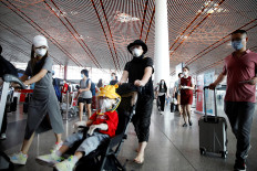 Travellers wearing protective gear are seen at the departure hall of Beijing Capital International Airport after scores of domestic flights in and out of the Chinese capital were cancelled following the new outbreak of the coronavirus disease (COVID-19) in Beijing, China June 17, 2020. 