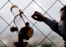 Cleanliness and hygiene expert Alain Miralles uses an swab to ensure that a telescope is clean as the Eiffel Tower gets ready to re-open to the public following the coronavirus outbreak, in Paris, France, June 17, 2020.  