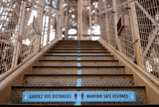 A sign reminding about social distancing is seen at the Eiffel Tower as she gets ready to re-open to the public following the coronavirus outbreak, in Paris, France, June 17, 2020.  