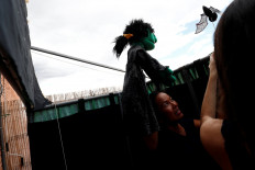 Actress and puppeteer Yohana Yara, who has used her time in lockdown to build an online fan base for her characters, performs with her colleague Alicia Lorente as Jerome Rader films their puppet show at her home following the coronavirus disease (COVID-19) outbreak in Madrid, Spain, on June 16, 2020. 