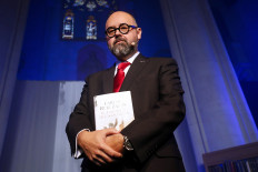 In this file photo taken on November 17, 2016 Spanish novelist Carlos Ruiz Zafon poses during the presentation of his book 'El laberinto de los espiritus' (The spirits' maze) at the Expiatory Church of the Sacred Heart of Jesus in Barcelona. 