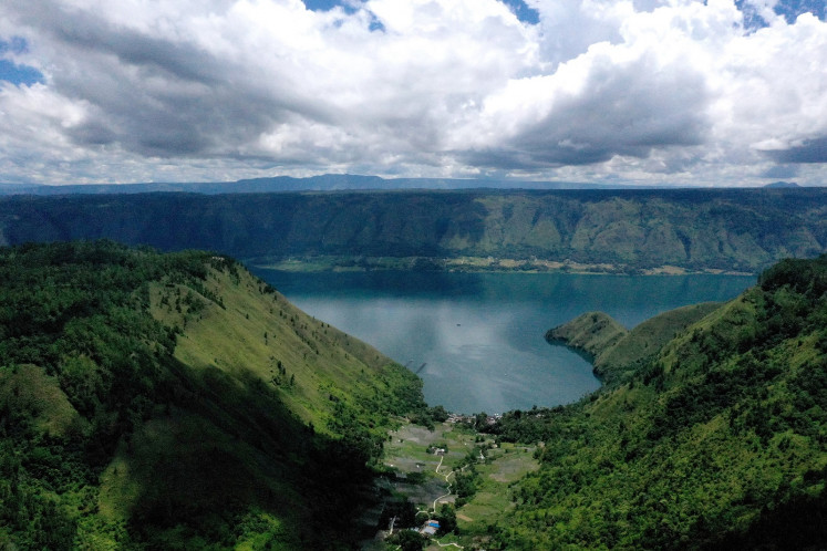This aerial picture taken on April 4 2019 shows Lake Toba, from Sigapitan, which covers some 1,707 square kilometers of North Sumatra, nearly twice the size of Singapore. The lake, formed by a gigantic volcanic eruption some 70,000 years ago, is the largest resurgent caldera on Earth. 