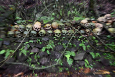 This picture taken on February 20, 2020 shows skulls at a cemetery where Bali's Trunyanese people hold open-air burials - before restrictions were implemented due to the COVID-19 coronavirus - near the village of Trunyan in Bangli Regency, near Lake Batur on Bali island. - For centuries Bali's Trunyanese people have left their dead to decompose in the open air, the bodies placed in bamboo cages until only the skeletons remain -- a ritual they haven't given up -- even as the COVID-19 pandemic upends burial practices worldwide.  AFP/Sonny Tumbelaka