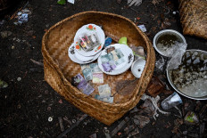 This picture taken on February 20, 2020 shows items left from ceremonial offerings for use in the afterlife scattered on the ground at a cemetery where Bali's Trunyanese people hold open-air burials - before restrictions were implemented due to the COVID-19 coronavirus - near the village of Trunyan in Bangli Regency, near Lake Batur on Bali island. - For centuries Bali's Trunyanese people have left their dead to decompose in the open air, the bodies placed in bamboo cages until only the skeletons remain -- a ritual they haven't given up -- even as the COVID-19 pandemic upends burial practices worldwide. AFP/Sonny Tumbelaka