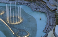 People observe social distancing while gathering to watch the Dubai fountain show, which resumes as the Gulf emirate emerges from a lockdown imposed due to the COVID-19 pandemic, on June 5, 2020.