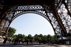 Visitors queue as they wait for the partial reopening of Eiffel Tower on June 25, 2020, in Paris, as France eases lockdown measures taken to curb the spread of the COVID-19 caused by the novel coronavirus. 