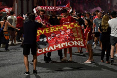 Fans celebrate Liverpool winning the Premier League title outside Anfield stadium in Liverpool, north west England on June 25, 2020.Liverpool raised the bar so high and enjoyed such a huge winning margin in claiming the Premier League title last season it would be churlish to doubt their credentials for a repeat showing.