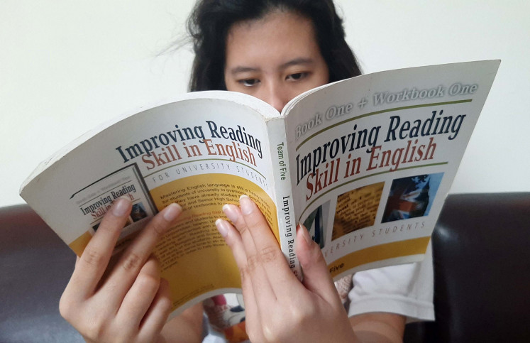Reading to learn: Ayra, a senior high school student in Jakarta, reads an English textbook. When you are learning a foreign language, reading books and materials in that language will help expand your vocabulary and refine your sense of grammar and usage.