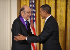 US President Barack Obama shakes hands with graphic designer Milton Glaser after presenting him with the 2009 National Medal of Arts during a ceremony in the East Room of the White House in Washington, DC on February 25, 2010. 