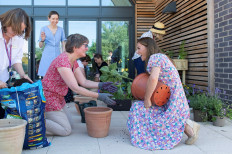 Britain's Catherine, Duchess of Cambridge, helps plant a tree as she visits the Nook Children's Hospice in Framingham Earl, Norfolk, Britain, on June 25, 2020.
