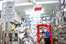 A plastic screen separates customers from the cashier at a clock shop in Santa Market in Jakarta on Tuesday. The screen was installed to protect the shop attendant from COVID-19. JP/Seto Wardhana