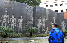 This photo taken on February 7, 2018 shows a tourist in the courtyard of Hoa Lo prison, dubbed the ‘Hanoi Hilton’, now a museum in the Vietnamese capital of Hanoi, where former US Navy pilot John McCain was held as a prisoner of war (POW) for five and a half years after his jet was shot down over a Hanoi lake in 1967. 