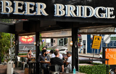 In this photo taken on June 19, 2020, people enjoy food and drinks at a restaurant in Bangkok.
