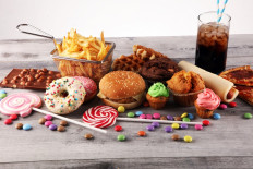 Britain will ban 'buy one get one free' promotions for food high in fat, sugar or salt and free refills of sugary soft drinks in restaurants from April 2022.