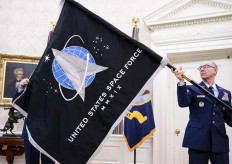 In this file photo taken on May 15, 2020, Gen. Jay Raymond (right), Chief of Space Operations presents US President Donald Trump with the official flag of the US Space Force in the Oval Office of the White House in Washington, DC.  