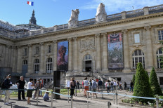 People queue outside the Grand Palais to visit the 'Pompeii' a new immersive 3D show on July 1, 2020 during the first day of the reopening in Paris.