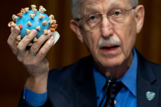 Director of the National Institutes of Health, Dr. Francis Collins, holds a model of the coronavirus as he testifies at a US Senate hearing to review Operation Warp Speed: the researching, manufacturing, and distributing of a safe and effective coronavirus vaccine, in Washington, DC, on July 2, 2020. 