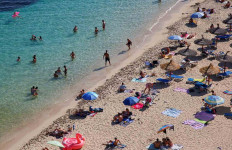 People sunbathe in Portals Nous beach, amid the coronavirus disease (COVID-19) outbreak in Palma de Mallorca, Spain on July 2, 2020. 