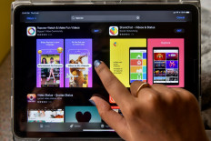 A woman browses on an online store the Indian app platforms Roposo and Sharechat in Bangalore on July 2, 2020. 