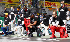 Formula One F1 - Austrian Grand Prix - Red Bull Ring, Spielberg, Styria, Austria - on Sunday   Mercedes' Lewis Hamilton, Ferrari's Sebastian Vettel and the rest of the drivers kneel on the grid wearing an anti-racism T-shirt before the race.