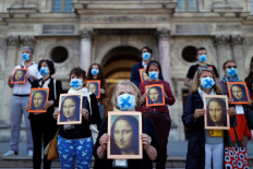 Don't forget us! Paris tour guides protest outside Louvre
