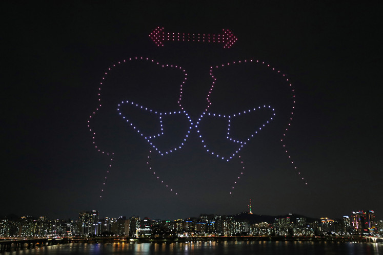 Drones fly over the Han river showing messages to support the country as a measure to avoid the spread of the coronavirus disease (COVID-19) continues in Seoul, South Korea, July 4, 2020. Picture taken July 4, 2020.   