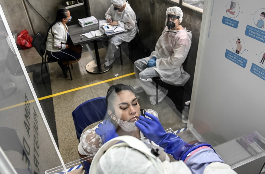 A woman is tested for COVID-19 during a random testing at a Metro station, amid the coronavirus pandemic, in Medellin, Colombia on Monday.Colombia's national lockdown to control the spread of coronavirus will be extended by just over two weeks until Aug. 1, President Ivan Duque said on Tuesday.
