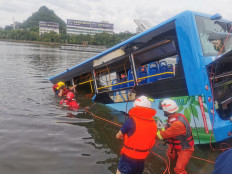 Toll rises from rain storms in China as student bus plunges into reservoir