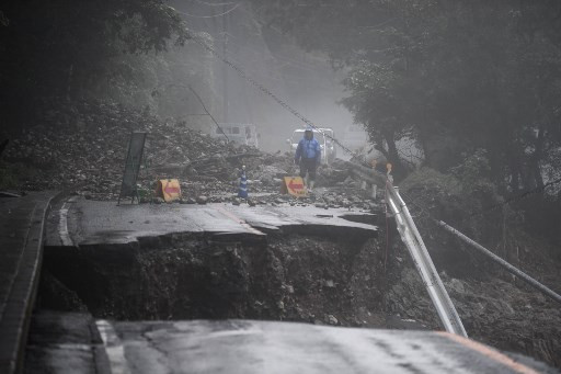 A collapsed road caused by heavy rain is seen in Kuma, Kumamoto prefecture on July 7, 2020. - Emergency services in western Japan were 
