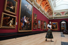 A member of staff wearing a protective face mask moves through a room inside the National Gallery on July 4, 2020, as the gallery prepares to reopen on July 8 following the easing of restrictions imposed during the novel coronavirus COVID-19 pandemic. 