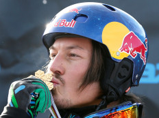 Australia's Alex Pullin kisses his medal on the podium after the men's snowboard-Cross finals at the FIS Snowboard World Championships in Stoneham, Quebec, Jan. 26, 2013, after winning the competition. 