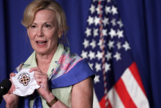 White House coronavirus response coordinator Deborah Birx holds up a mask as she speaks during a White House Coronavirus Task Force press briefing at the US Department of Education July 8, 2020 in Washington, DC. 
