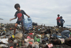 Children collect trash on July 9, 2020, at Muaro Lasak Beach, Padang, West Sumatra. Then Environment and Forestry minister Siti Nurbaya Bakar said that waste accumulation in 2020 was estimated to reach 67.8 million tonnes.