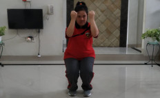 Gita Larasati, an intellectually challenged student athlete, trains in her house during the COVID-19 pandemic.