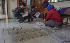 SMP 4 Bawang teachers in Batang regency, Central Java, sort assignment sheets before delivering them to students. Antara/Harviyan Perdana Putra