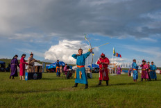 This photo taken on July 11, 2020 shows competitors during an archery competition at the annual Naadam sports festival near Ulaanbaatar, in Mongolia. 