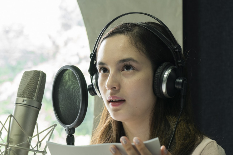 Deep in her role: Actress Chelsea Islan records her lines for Sandiwara Sastra, in which she voices Lalita from Ayu Utami’s novel of the same title.