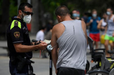 Spain region orders lockdown as global infections gather pace
