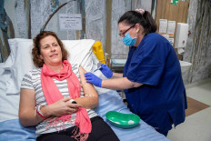 A volunteer is seen during a coronavirus disease (COVID-19) vaccine development announcement, made by the University of Queensland, in Brisbane, Australia, July 13, 2020.  