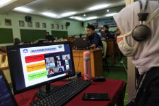 Teachers talk to students on the first day of the 2020-2021 school year at SMAN 8 state high school in Jakarta on July 13, 2020.