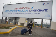 A passenger arrives at Jorge Chavez International Airport in Lima on July 15, 2020 as airports across Peru reopened for domestic flights as part of the easing of measures against the COVID-19 novel coronavirus pandemic.
