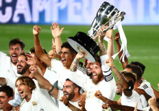 Real Madrid's Sergio Ramos and teammates celebrate with the trophy after winning La Liga by beating Villarreal 2-1 at home as play resumes behind closed doors following the outbreak of the COVID-19.