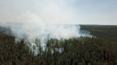 An aerial view shows smoke rising from a forest fire burning in Krasnoyarsk region, Russia, in this still image taken from undated handout video obtained by Reuters on July 10, 2020. 