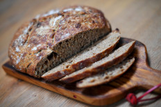 A first-attempt at a homemade seeded sourdough loaf is seen on a kitchen table in London, Britain, on April 3, 2020. 