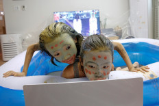 Children play in a mud pool during the Online Boryeong Mud Festival at their home during a live streaming event, in Gwangju, Gyeonggi-do, South Korea, July 18, 2020. 