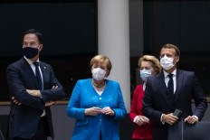 Netherlands' Prime Minister Mark Rutte (left) looks on next to Germany's Chancellor Angela Merkel (second left), President of the European Commission Ursula von der Leyen (second right) and France's President Emmanuel Macron prior the start of the European Council building in Brussels, on July 18, 2020, as the leaders of the European Union hold their first face-to-face summit over a post-virus economic rescue plan. - The EU has been plunged into a historic economic crunch by the coronavirus crisis, and EU officials have drawn up plans for a huge stimulus package to lead their countries out of lockdown