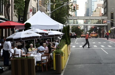 People enjoy outside dining in a restaurant in Manhattan on July 18, 2020 in New York City. 